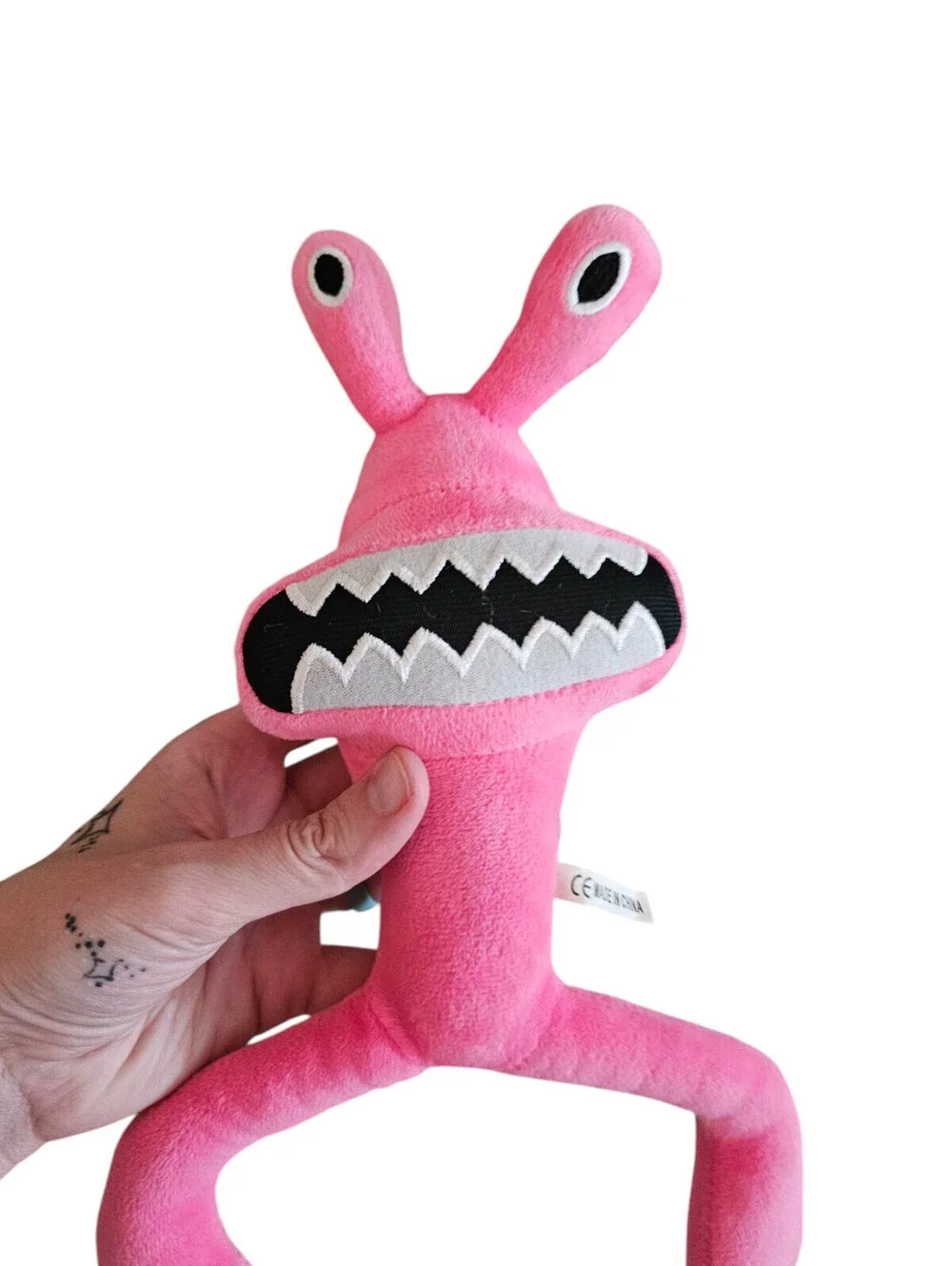 Rainbow Friends plush toy is a bright pink character